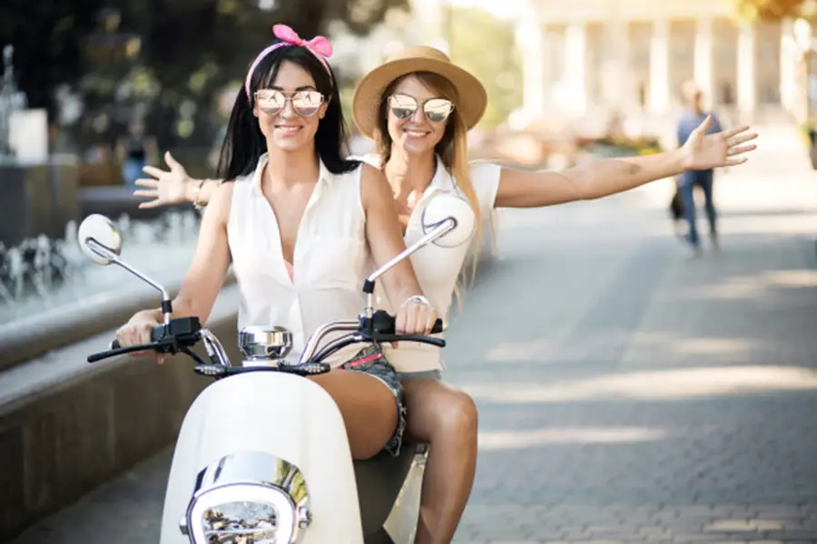 two girls on a scooter - the best 50cc scooters